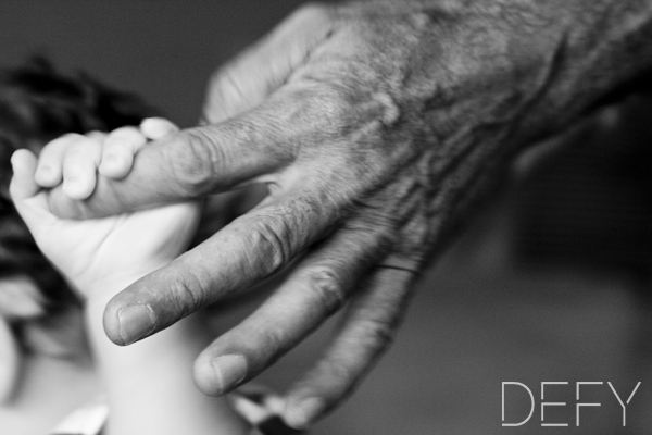 small hand holding parents finger