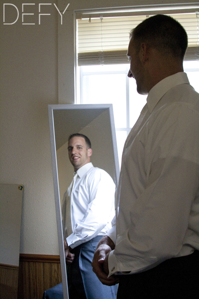 groom looking in mirror