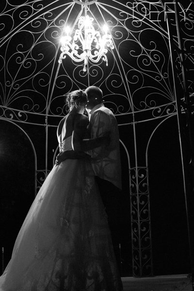 bride and groom under the gazebo