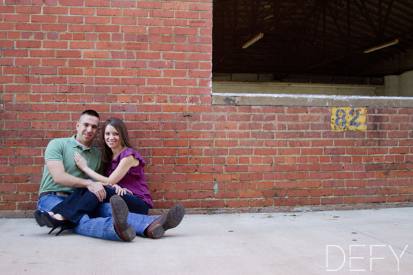 Sitting in front of brick wall