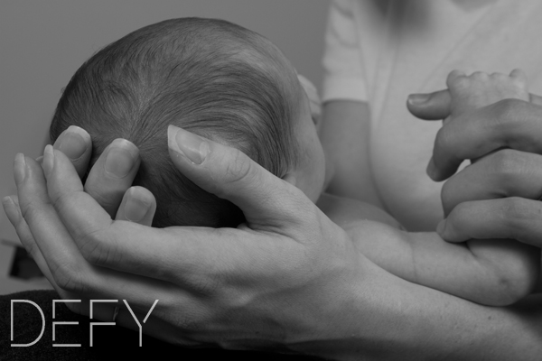 Mommys hands holding baby head