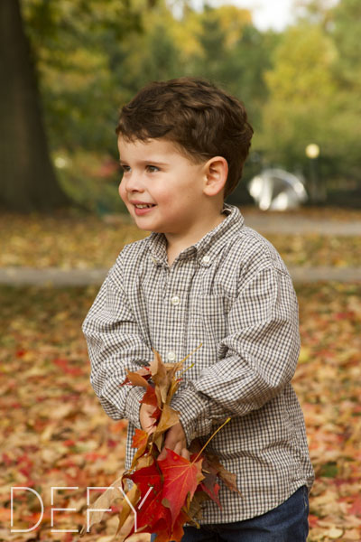 boy playing with leaves